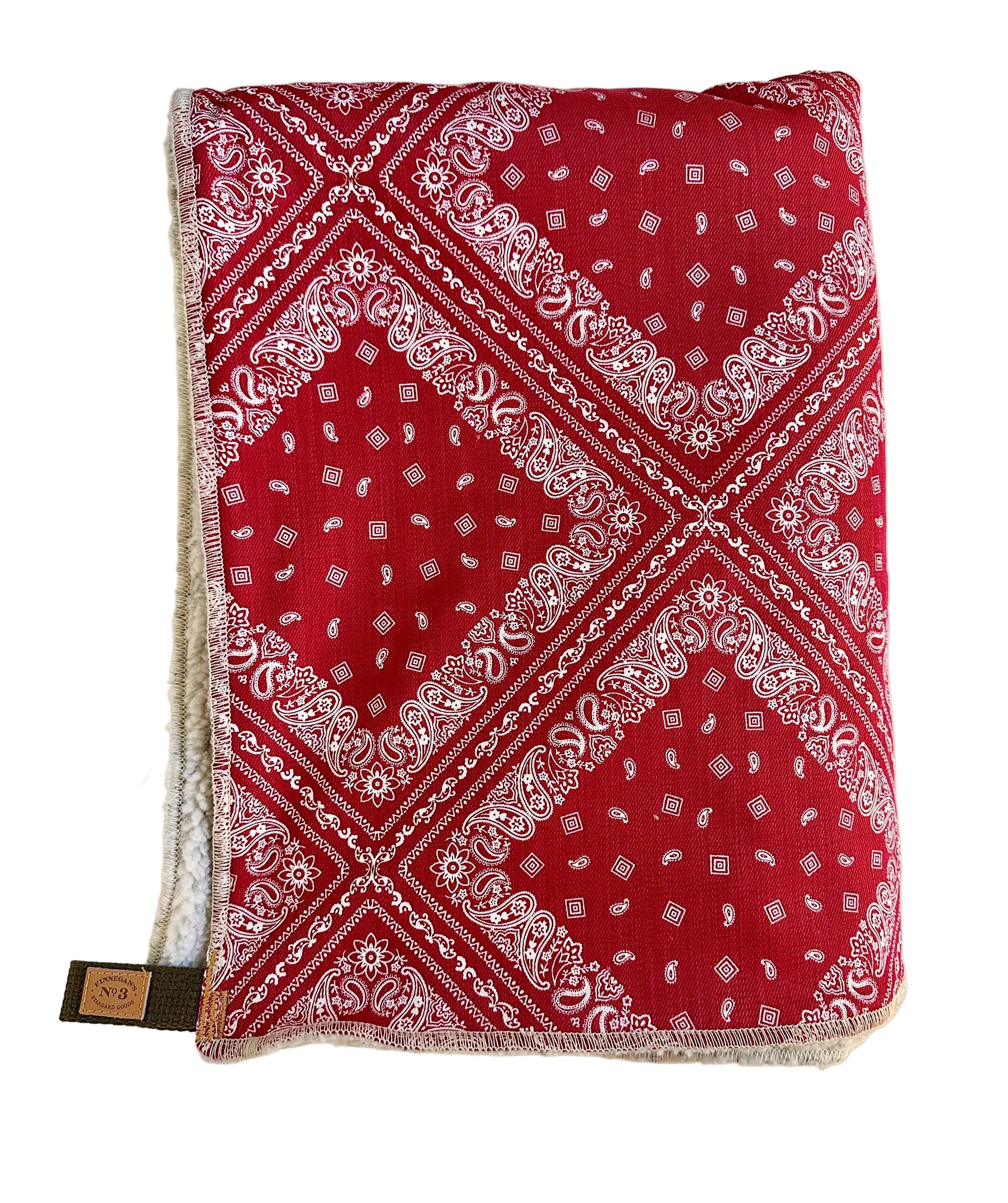 Red bandana with white patterns on a light beige background