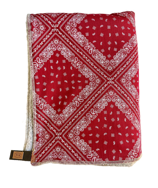 Red bandana with white patterns on a light beige background