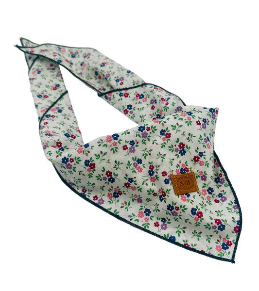 Floral patterned bandana with a brand tag on a white background